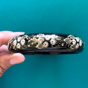 Black lacquered bangle bracelet. Always a fun accent piece for your ward…